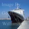 GW17431-50 = Cruise ship Queen Elizabeth II (QE2) with Palma Cathedral behind in the Port of Palma de Mallorca, Balearic Islands, Spain.
