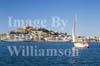 GW11320-50 = View over the harbour with sailing boat towards the port and historic Ibiza Town (Cathedral of Our Lady of the Snows + fortifications), Ibiza, Balearic Islands, Spain. 1996. 