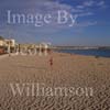 GW19540-50 = Late afternoon view - lady walking over beach - looking East along Playa de Palma ( Platja de Palma ) beach, Palma de Mallorca, Balearic Islands, Spain.