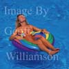 GW25106-50 = Young bikini clad lady floating in a rubber ring in the swimming pool of a country finca, Mallorca, Balearic Islands, Spain. 