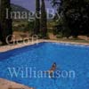 GW25405-50 = Young nude lady swimming in the swimming pool of a country finca, Mallorca, Balearic Islands, Spain. 