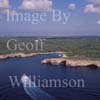 GW27905-60 = Aerial view - Coastguard vessel approaching a remote rocky cala / bay / anchorage - South West Menorca, Balearic Islands, Spain. 20th September 2006. 