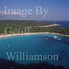 GW28060-60 = Aerial view - large remote cala / bay with long sandy beach and leisure craft at anchor - looking Eastwards along the rugged South Coast of Menorca, Balearic Islands, Spain. 20th September 2006. 