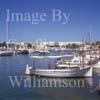 GW29580-60 = Morning scene looking West - traditional Mallorquin wooden llauts, moored sail and motor yachts and departing motor yacht - Cala D'Or Marina, Cala D'Or, Santanyi, South East Mallorca, Balearic Islands, Spain. 7th July 2007.