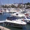 GW29665-60 = View looking North West over Cala D'Or marina with moored sailing and motor yachts, marina side apartment blocks and distant inland hills, Cala D'Or, Santanyi, South East Mallorca, Balearic Islands, Spain. 7th July 2007.