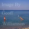 GW30260-60 = Scene at Cala Agulla - young couple playing volleyball in the sea - idyllic sandy bay close to Cala Ratjada, North East Mallorca, Balearic Islands, Spain. 9th September 2007. Verbal Model Release.