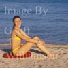 GW30736-60 = Young lady performing pre swim yoga, fitness, exercise and meditation at Puerto Alcudia beach, North East Mallorca, Balearic Islands, Spain. 11th November 2007. Model Release.