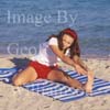 GW30781-60 = Young lady performing pre swim yoga, fitness, exercise and meditation at Puerto Alcudia beach, North East Mallorca, Balearic Islands, Spain. 11th November 2007. Model Release.