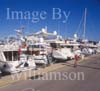 GW31020-60 = Scene in Alcudiamar marina with young lady in-line skater and luxury motor yachts, Puerto Alcudia, North East Mallorca, Balearic Islands, Spain. 11th November 2007. Model Release.