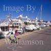 GW31025-60 = Scene in Alcudiamar marina with young lady in-line skater and luxury motor yachts, Puerto Alcudia, North East Mallorca, Balearic Islands, Spain. 11th November 2007. Model Release.