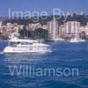 GW32330-60 = Boat Show Bound - Elegance 60 motor yacht ( with Belver Castle and Paseo Maritimo in the background ) heading for Palma International Boat Show 2008 in Old Port ( Moll Vell / Muelle Viejo ) Area of the Port of Palma de Mallorca, Balearic Islands, Spain. 24th April 2008.