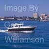 GW32390-60 = Boat Show Bound ???- motor yacht with historic Porto Pi lighthouse in the background heading for Palma International Boat Show 2008 in Old Port ( Moll Vell / Muelle Viejo ) Area of the Port of Palma de Mallorca, Balearic Islands, Spain. 24th April 2008.