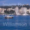 GW32415-60 = Boat Show Bound  - wooden llaut ( with Belver Castle and Paseo Maritimo in the background ) heading for Palma International Boat Show 2008 in Old Port ( Moll Vell / Muelle Viejo ) Area of the Port of Palma de Mallorca, Balearic Islands, Spain. 24th April 2008.