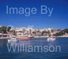 GW33615-60 = 60 Scene in Porto Cristo with boats entering the marina + beach and resort in the background, East Coast Mallorca / Majorca, Balearic Islands, Spain. 5th October 2008. 