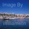 GW33620-60 = Scene in Porto Cristo, with Menorquin yacht entering the marina, tourist excusion boat behind and beach + resort in the background, East Coast Mallorca / Majorca, Balearic Islands, Spain. 5th October 2008.