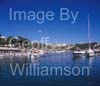 GW33625-60 =  Scene in Porto Cristo, with traditional mallorquin wooden boat entering the marina and beach + resort in the background, East Coast Mallorca / Majorca, Balearic Islands, Spain. 5th October 2008. 