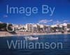 GW33660-60 = Scene in Porto Cristo with pleasure craft / boat entering Porto Cristo marina and with sandy beach and resort in the background, East Coast Mallorca / Majorca, Balearic Islands, Spain. 5th October 2008.