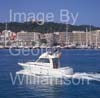 GW34270-60 = Starfisher 840  ( 8 mtrs ) homeward bound  from Palma International Boat Show 2009 with historic Bellvar Castle in the background, Port of Palma de Mallorca, Balearic Islands, Spain. 4th May 2009.