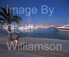 GW34675-60 = Young lady eating ice cream roller blading along Paseo Maritimo past luxury yacht marina with Palma Cathedral in the background, Palma de Mallorca / Majorca, Balearic Islands, Spain. 13th August 2009. Model Release.