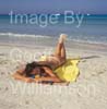 GW35050-60 = Young topless lady enjoying sun, sea and sand on Es Trenc beach ( with boats at anchor behind ) in SE Mallorca / Majorca, Balearic Islands, Spain.  17th August 2009. Model Release.